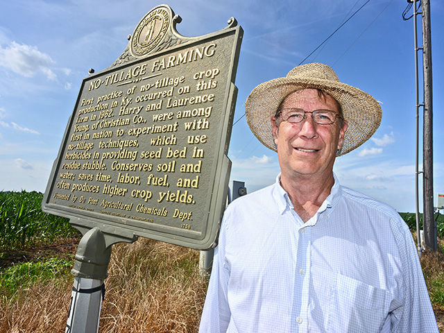 John Young stands with a marker highlighting his family-farmâ€™s distinction of being an early no-till adopter, Image image by Charles Johnson 